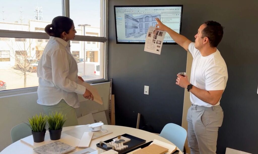 architectural designer and project manager looking over plans of custom home