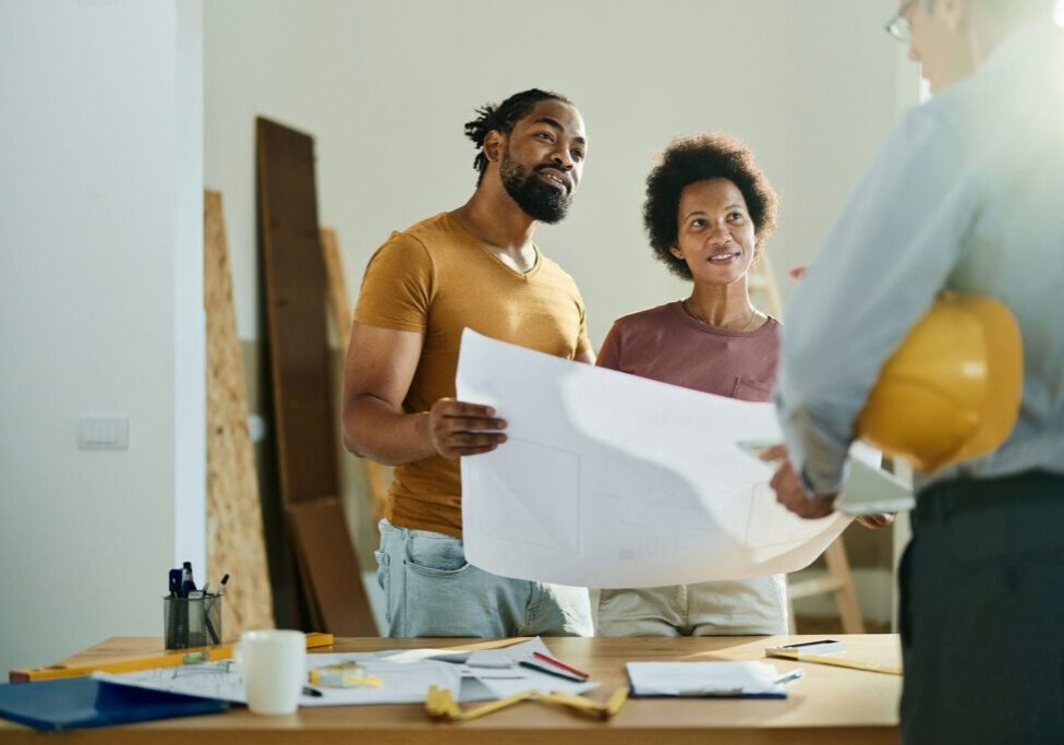 condo renovation contractor reviewing scheudle with owners